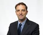 A person in a suit

Description automatically generated with medium confidence