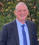 A person in a suit and tie

Description automatically generated with medium confidence
