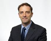 A person in a suit

Description automatically generated with medium confidence